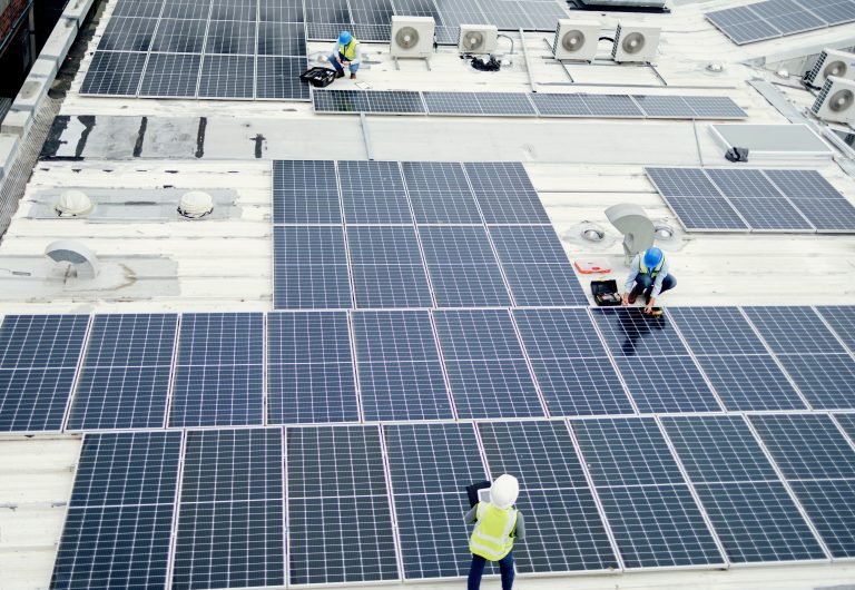 Grid, solar energy and roof construction engineering people working on renewable energy installation. Sustainability, solar panel and professional contractor team work on building rooftop